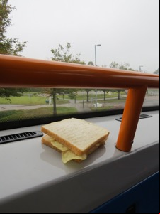 White crisp sandwich placed by the window of a bus
