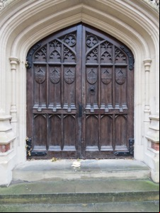 Roll containing crisps in front of large, ornate door