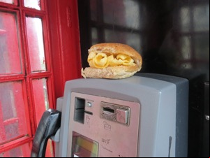 Brown Quavers roll on top of phone unit in a phone box