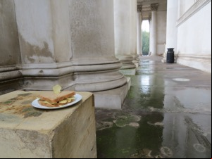 Crisp sandwich with crisp stuck in it in front of columns