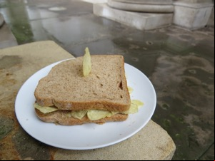 Crisp sandwich with crisp stuck in it on a plate