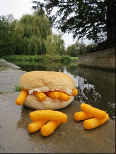Roll containing and alongside Wotsits placed by water