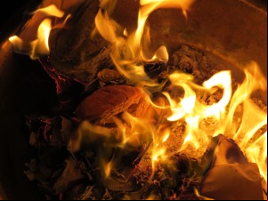 Brown crisp roll in among burning paper