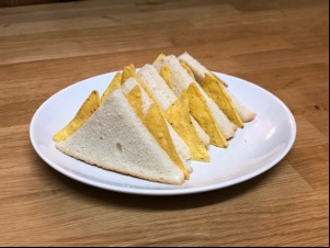 Small diagonally-cut white Dorito sandwiches