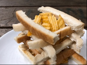 Close-up of lattice of crusts and crinkle-cut crisps
