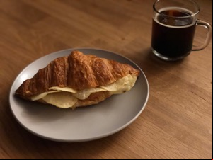 Crisp croissant alongside drink