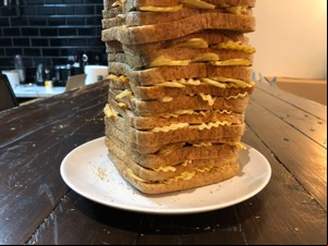 Lower half of brown loaf filled with crinkle-cut crisps