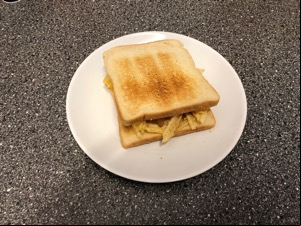 Crinkle-cut crisps between slices of white toast