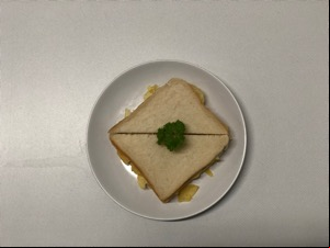 Overhead view of garnished white crisp sandwich