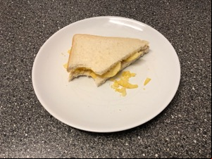 Diagonally-cut crisp sandwich with a bitten corner