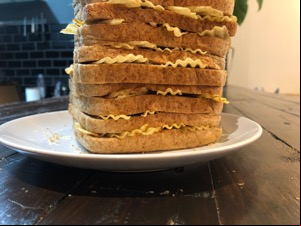 Lower part of a whole brown loaf filled with crisps