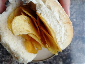 Close up of handheld crisp-filled white roll