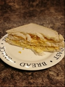 Half of a double decker white crisp sandwich