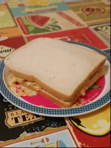 White potato crisp sandwich on a plate on a tablecloth