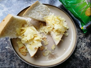 Two open baguette segments with crisps on