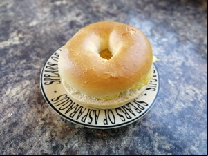 Crisp-filled bagel on a typographic plate