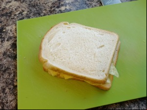 Crisp-filled white sandwich on a cutting board