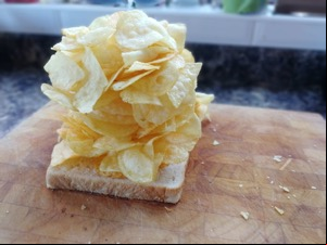 Oodles of crisps piled onto white bread
