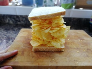 White bread containing a big pile of potato crisps