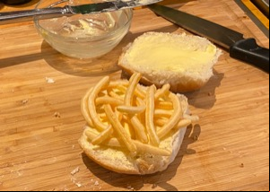 French Fries snacks on bread roll alongside knife