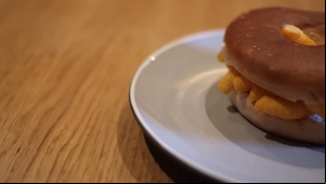 Panning across to a bagel filled with Wotsits