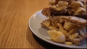 Panning across to a brown Quavers sandwich