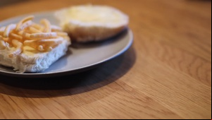 Turning to reveal French Fries on an open white roll