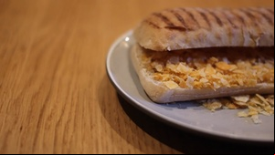 Panning across to a crushed crisp panini